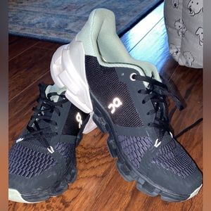 On cloud, size 7.5. Black and light mint green, worn less than 3 times